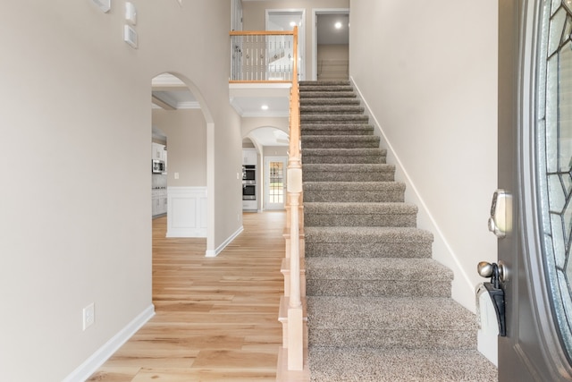 entryway with light hardwood / wood-style floors and ornamental molding