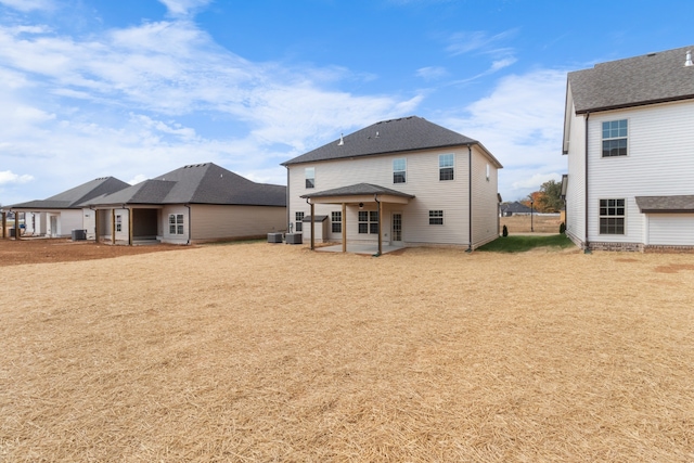 back of property featuring a patio, cooling unit, and a lawn