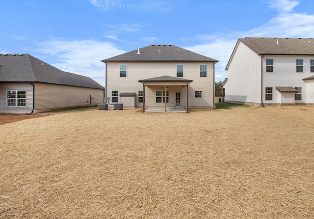 rear view of house featuring a yard, cooling unit, and a patio