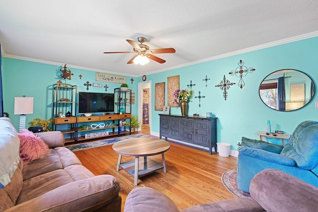 living room with ornamental molding, hardwood / wood-style floors, a textured ceiling, and ceiling fan