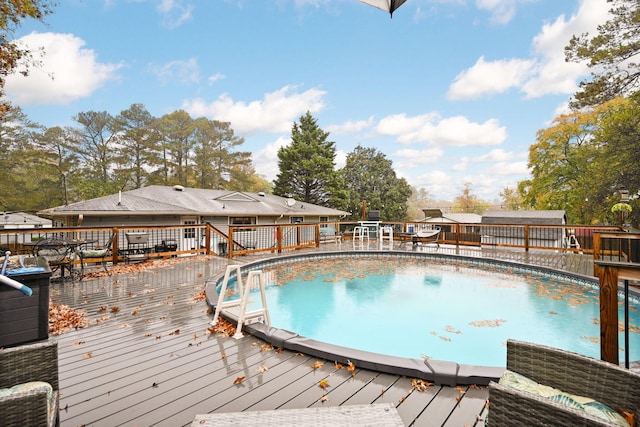 view of swimming pool featuring a wooden deck