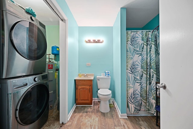 washroom with sink, stacked washer and clothes dryer, and wood-type flooring