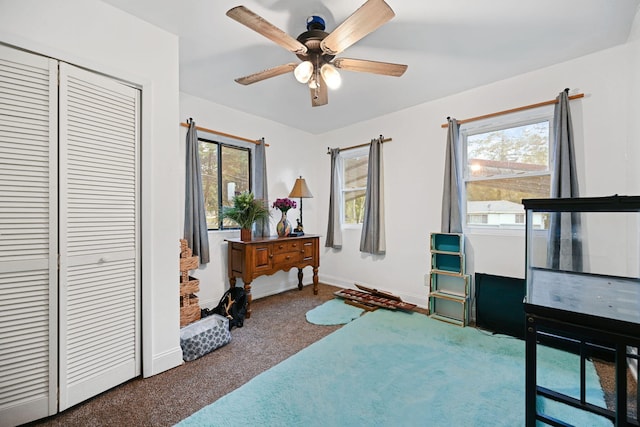 interior space with carpet and ceiling fan