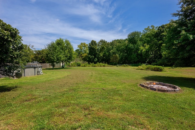 view of yard with a fire pit