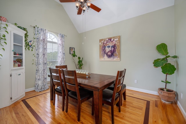 dining area featuring vaulted ceiling, light hardwood / wood-style floors, and ceiling fan