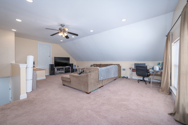 carpeted living room with ceiling fan and lofted ceiling