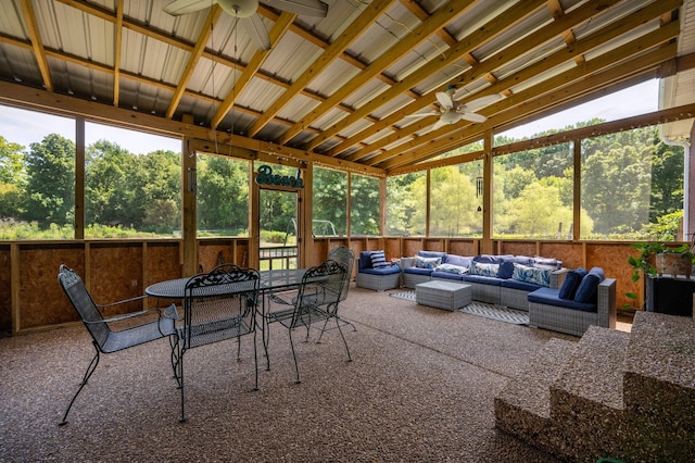 sunroom / solarium featuring ceiling fan, lofted ceiling, and plenty of natural light