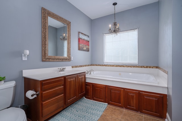 bathroom featuring a tub, an inviting chandelier, toilet, vanity, and tile patterned flooring