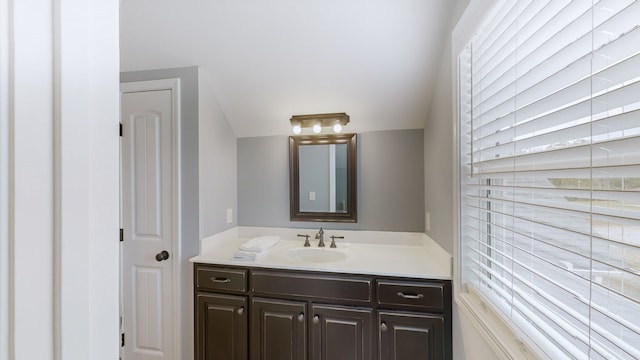 bathroom with vanity and vaulted ceiling