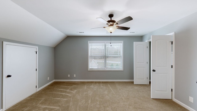 additional living space with light carpet, vaulted ceiling, and ceiling fan