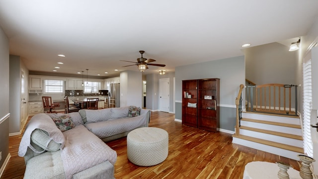 living room featuring hardwood / wood-style flooring and ceiling fan