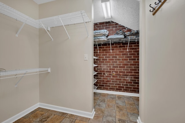 walk in closet with lofted ceiling