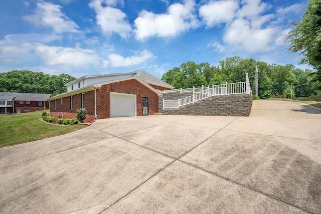 view of home's exterior featuring a yard and a garage