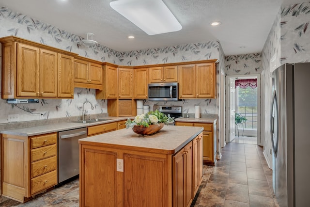 kitchen featuring sink, a center island, and stainless steel appliances