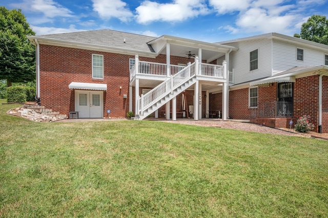 back of property with a patio area, a yard, and ceiling fan