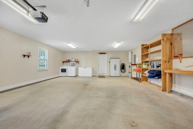 garage featuring a garage door opener, white fridge, and washing machine and dryer