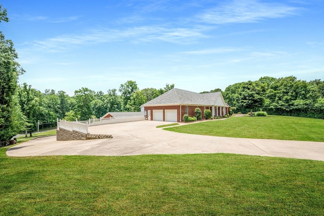 ranch-style house with a garage and a front lawn