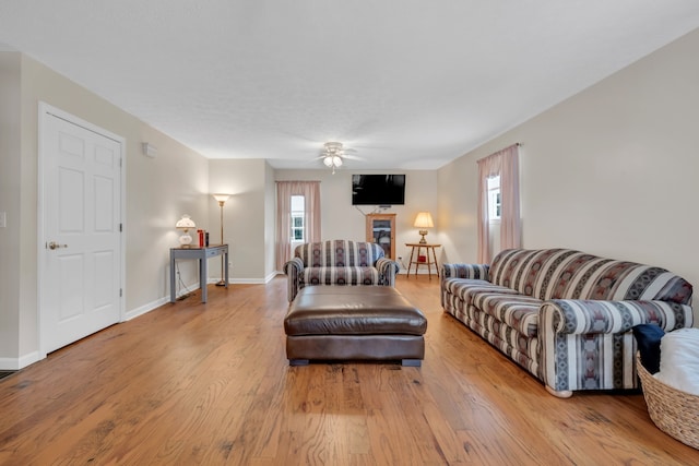 living room with light wood-type flooring and ceiling fan