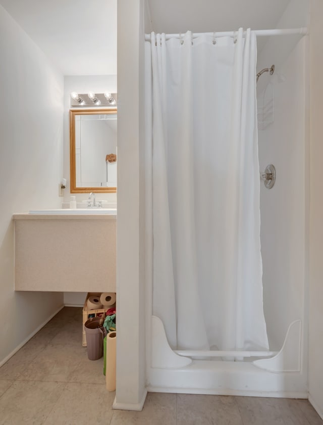 bathroom with shower / bath combination with curtain and tile patterned flooring