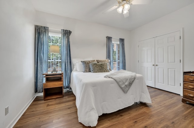 bedroom with a closet, hardwood / wood-style flooring, and ceiling fan