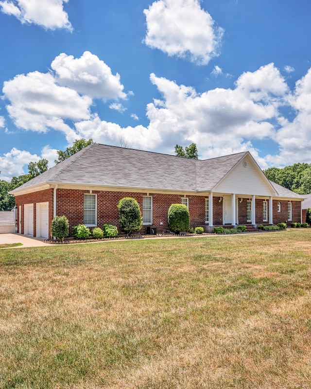 single story home featuring a front yard and a garage