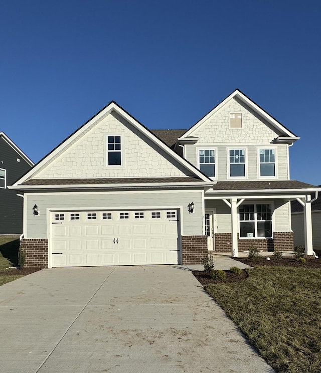 view of front of home featuring covered porch and a garage