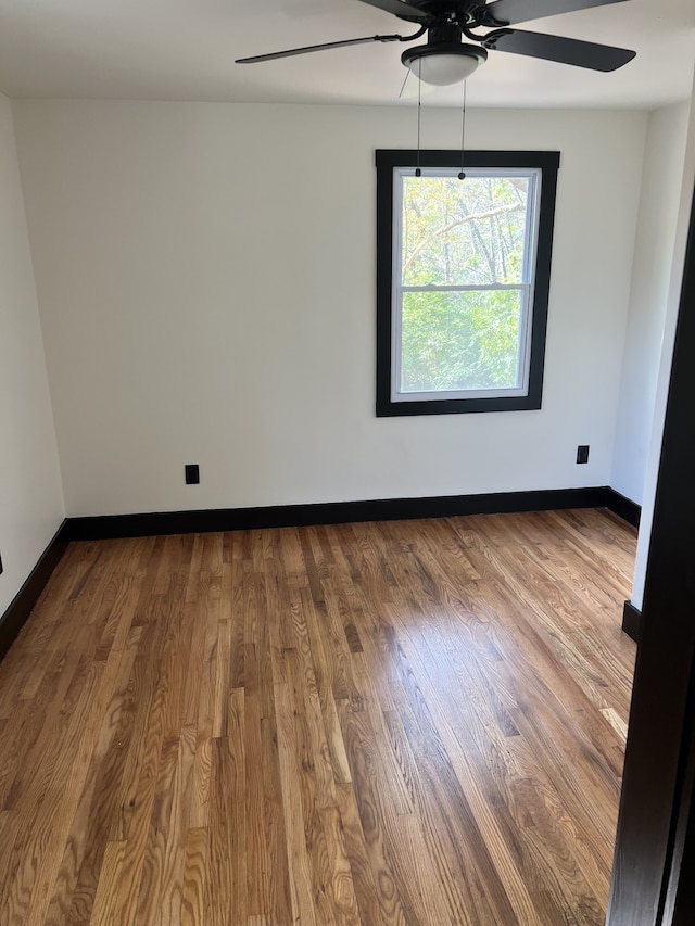 empty room featuring hardwood / wood-style floors and ceiling fan