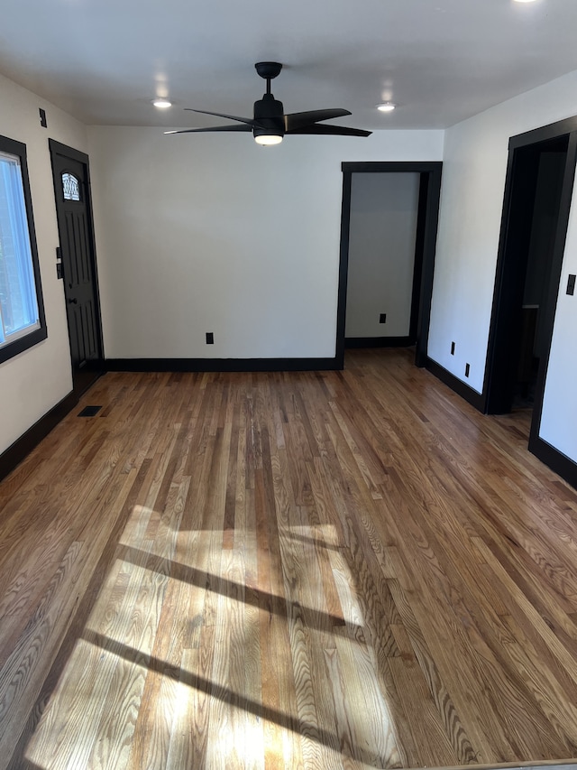 interior space with hardwood / wood-style floors and ceiling fan