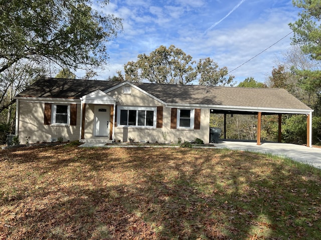 ranch-style home featuring a front yard and a carport