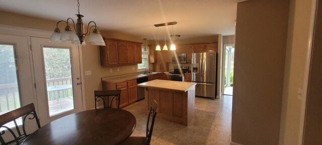 104 Oak Crest Dr, Tennessee Ridge, TN 37178 - kitchen featuring stainless steel appliances, a chandelier, a sink, light countertops, and a center island