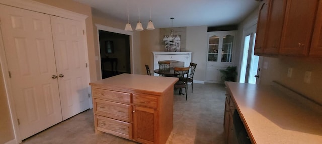104 Oak Crest Dr, Tennessee Ridge, TN 37178 - kitchen featuring light countertops, a chandelier, decorative light fixtures, a kitchen island, and brown cabinets