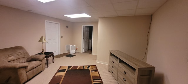 carpeted living room with a drop ceiling