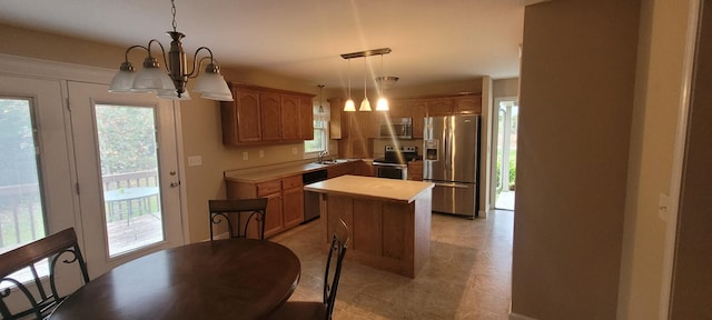 104 Oak Crest Dr, Tennessee Ridge, TN 37178 - kitchen featuring appliances with stainless steel finishes, a sink, a chandelier, a center island, and light countertops
