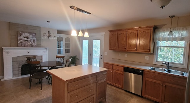 kitchen featuring sink, stainless steel dishwasher, hanging light fixtures, a notable chandelier, and a center island