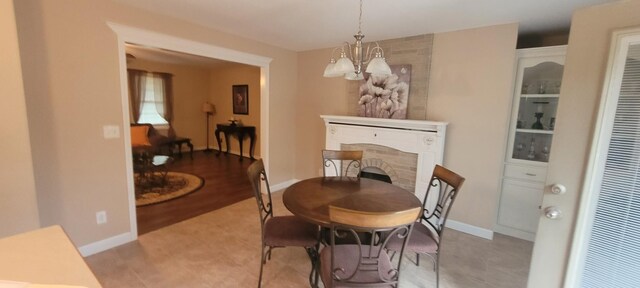 104 Oak Crest Dr, Tennessee Ridge, TN 37178 - dining space featuring a chandelier, a heating unit, a brick fireplace, and baseboards