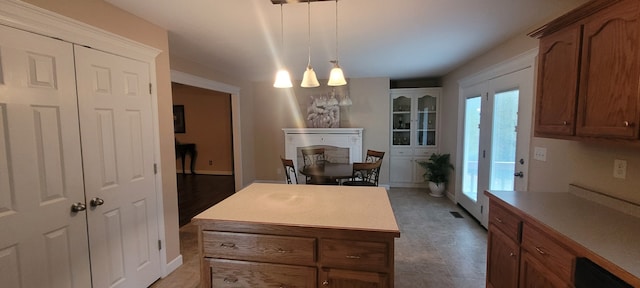 kitchen with dark hardwood / wood-style flooring, a notable chandelier, dishwashing machine, a kitchen island, and pendant lighting