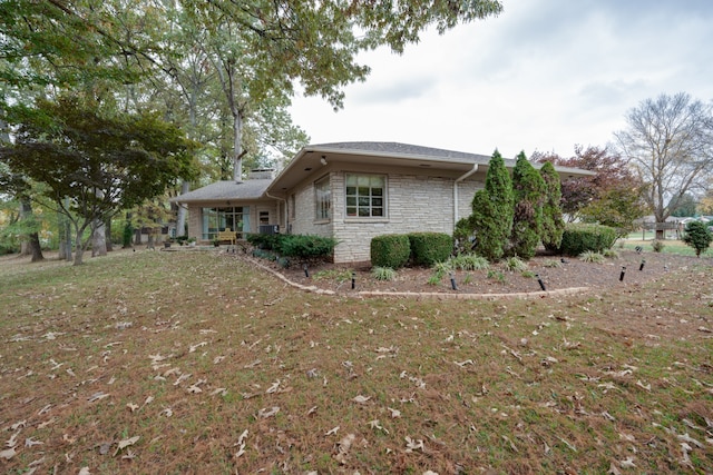 view of side of home featuring a yard