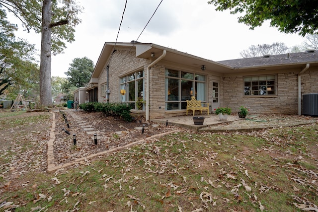 back of house with a patio area and central AC unit