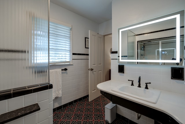 bathroom featuring tile patterned floors, tile walls, and sink