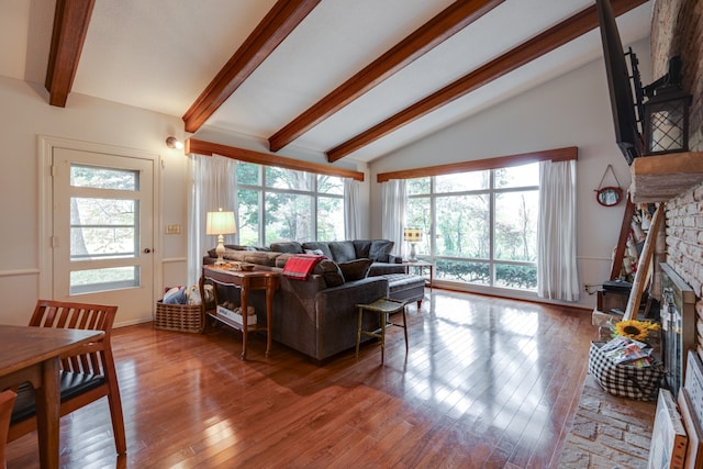 living room featuring a fireplace, wood-type flooring, and lofted ceiling with beams