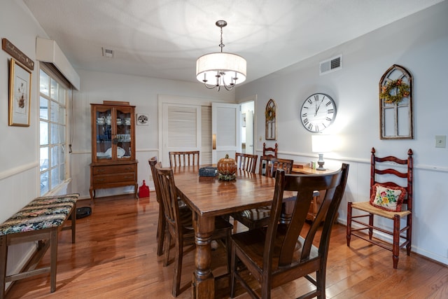 dining space featuring a chandelier and wood-type flooring