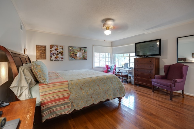 bedroom featuring hardwood / wood-style floors, ceiling fan, and a textured ceiling