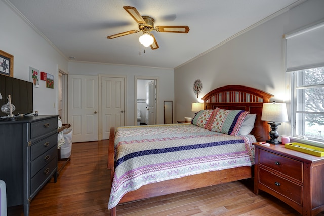 bedroom featuring hardwood / wood-style floors, ceiling fan, ornamental molding, and ensuite bathroom