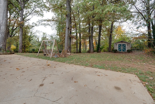 view of yard featuring a storage unit and a patio area