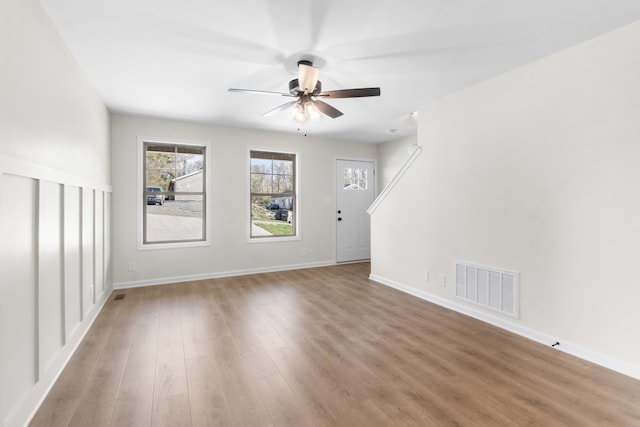 unfurnished living room with ceiling fan and hardwood / wood-style floors