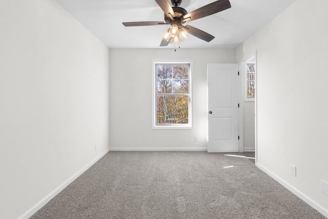 carpeted empty room featuring ceiling fan