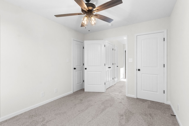 unfurnished bedroom with ceiling fan and light carpet