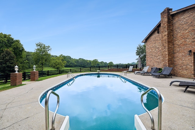 view of swimming pool with a patio