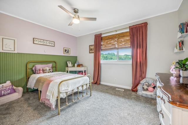 carpeted bedroom featuring ceiling fan and ornamental molding