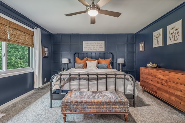 carpeted bedroom with ceiling fan and ornamental molding